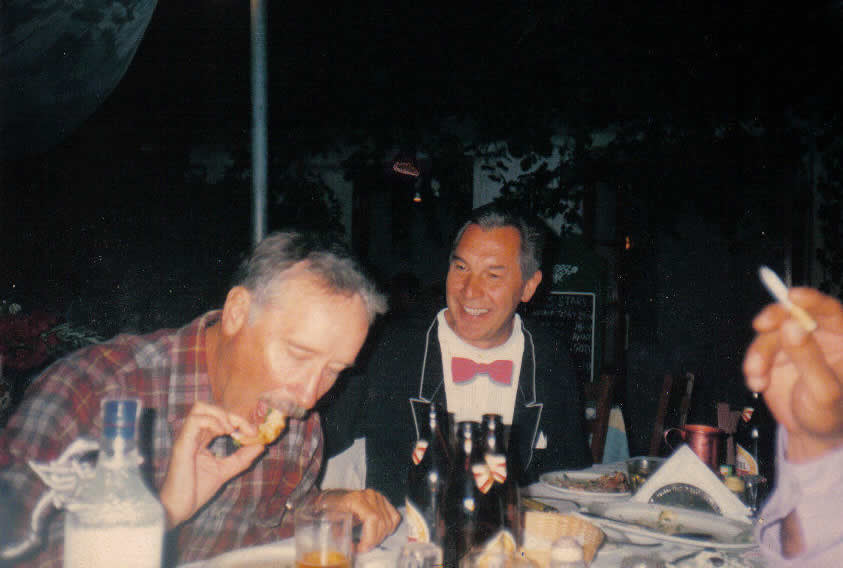 Michael in "tux" with Captian Brian munching on a prawn 1998